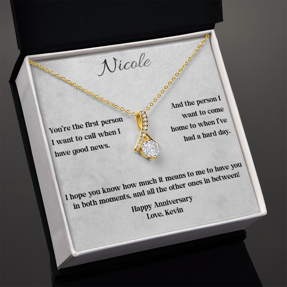 Yellow gold anniversary necklace and card in a standard gift box