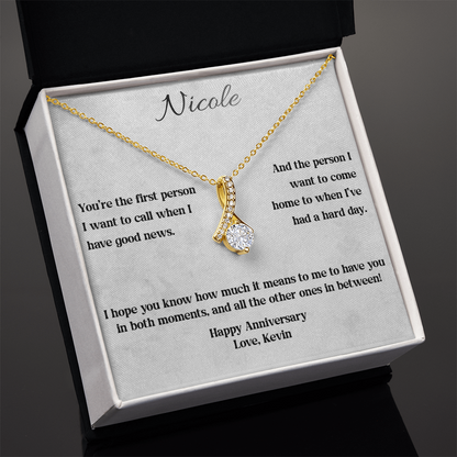Yellow gold anniversary necklace and card in a standard gift box