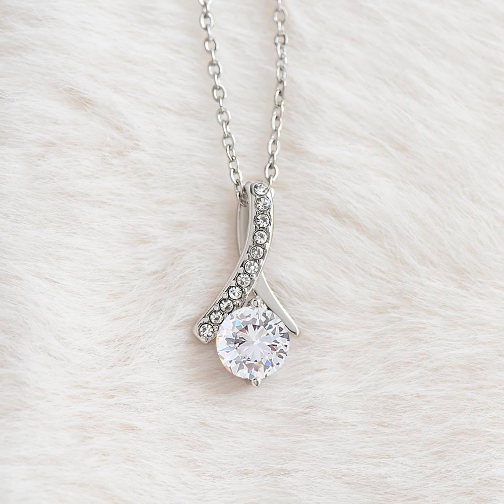 White gold Alluring Beauty necklace pendant with cubic zirconia on soft white fabric