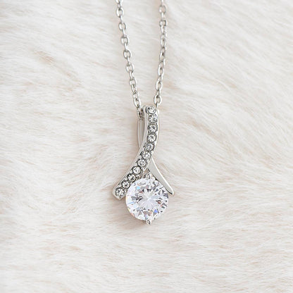 White gold Alluring Beauty necklace pendant with cubic zirconia on soft white fabric