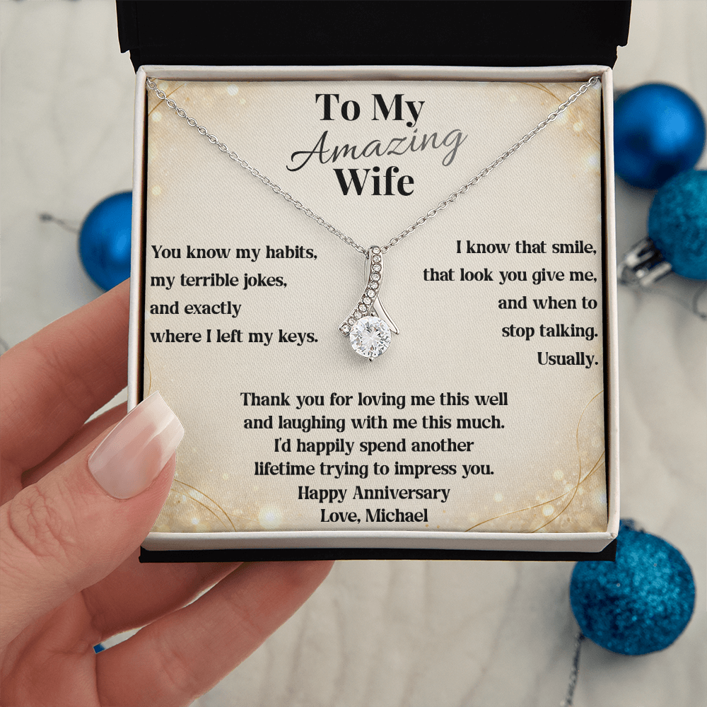 White gold anniversary necklace and To My Amazing Wife card held beside blue ornaments