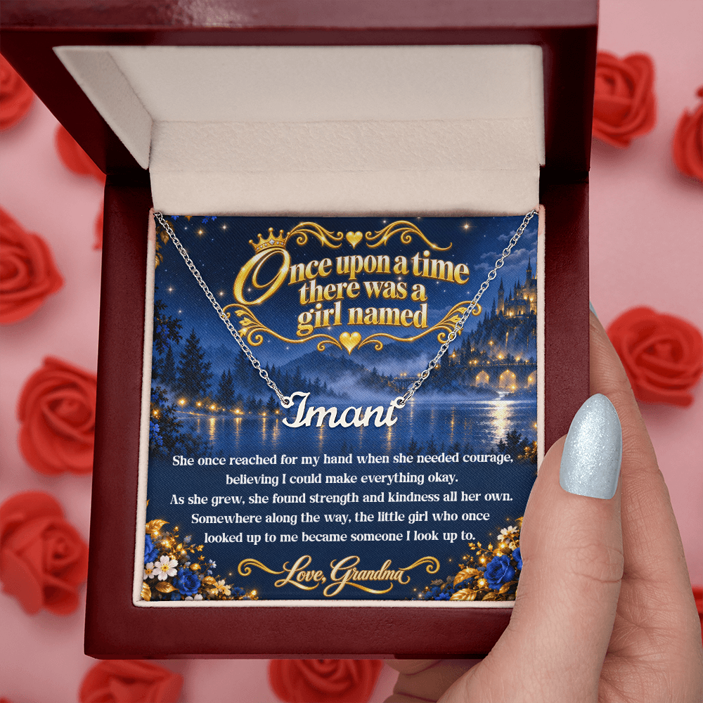 Silver-tone Imani name necklace in an open wood-style gift box with a Once Upon a Time card from Grandma and red roses behind.