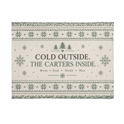 Flat view of the personalized Cold Outside, Family Inside blanket artwork in cream and sage, with sample Carter family names.